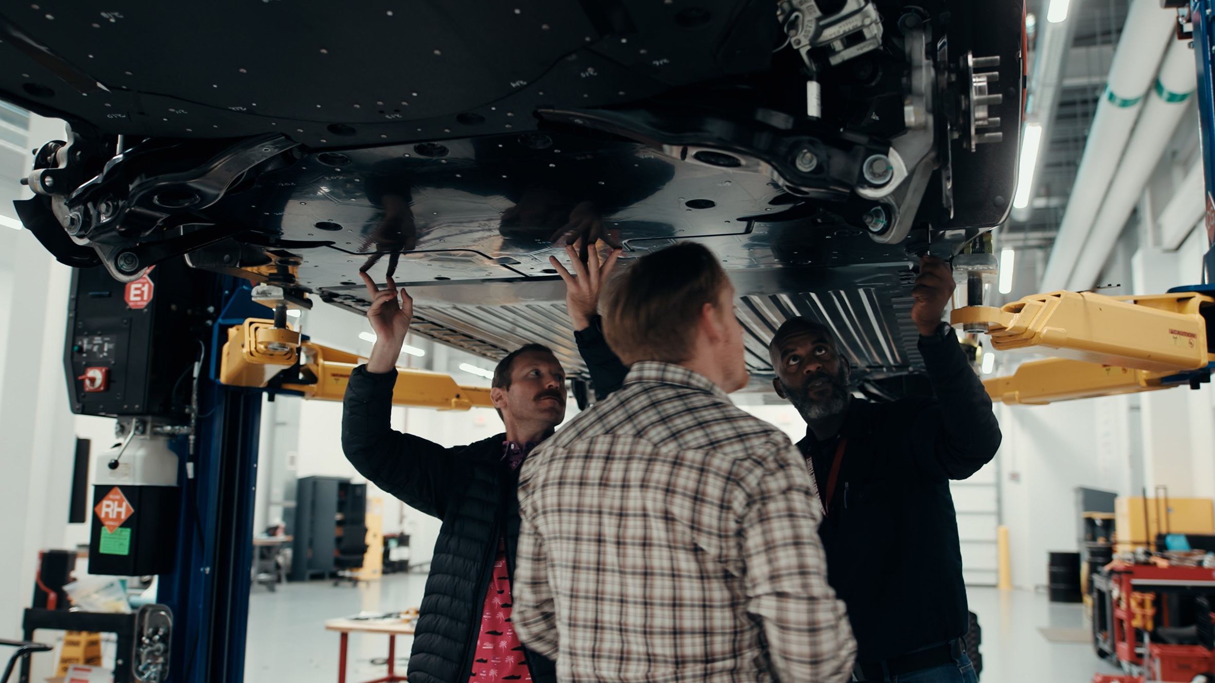 Universal EV Platform team at the Vehicle Performance and Electrification Center (VPEC) working on the underbody shield.